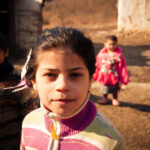 serednie-ukraine-march-09-2011-portrat-of-romani-schoolgirl-looking-at-the-camera-younger-siblings_t20_JJYomO.jpg